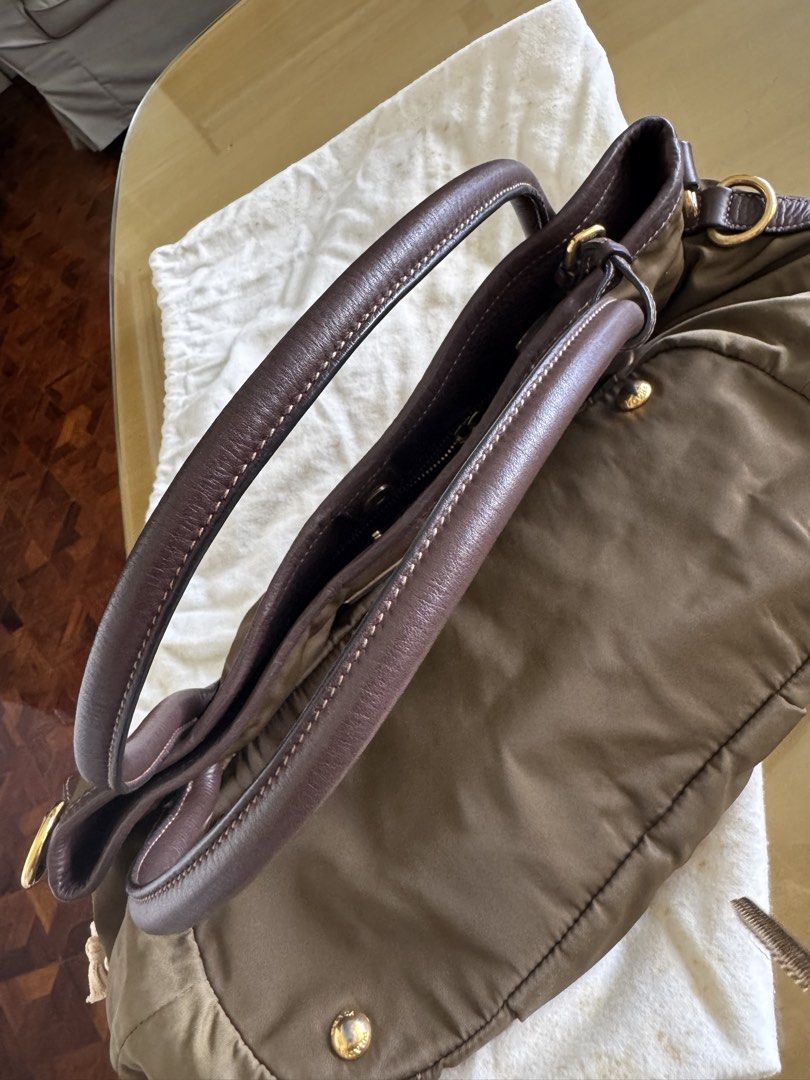 Prada Nylon Bag (Category: Luxury Bags & Wallets) located in Paranaque City. Submitted by starurot (Listing ID 1435549878, Image 2). Description: - Authentic Prada Vitello Daino Trimmed Tessuto Satchel BR 4420 - Brown color - Nylon body with leather trim - Detachable shoulder strap - Gold-tone hardware - Prada logo visible - Includes dust bag Used less than 10x Stored only Rfs: no need for this, decluttering MOP: BDO/ Gcash SF to be shouldered by