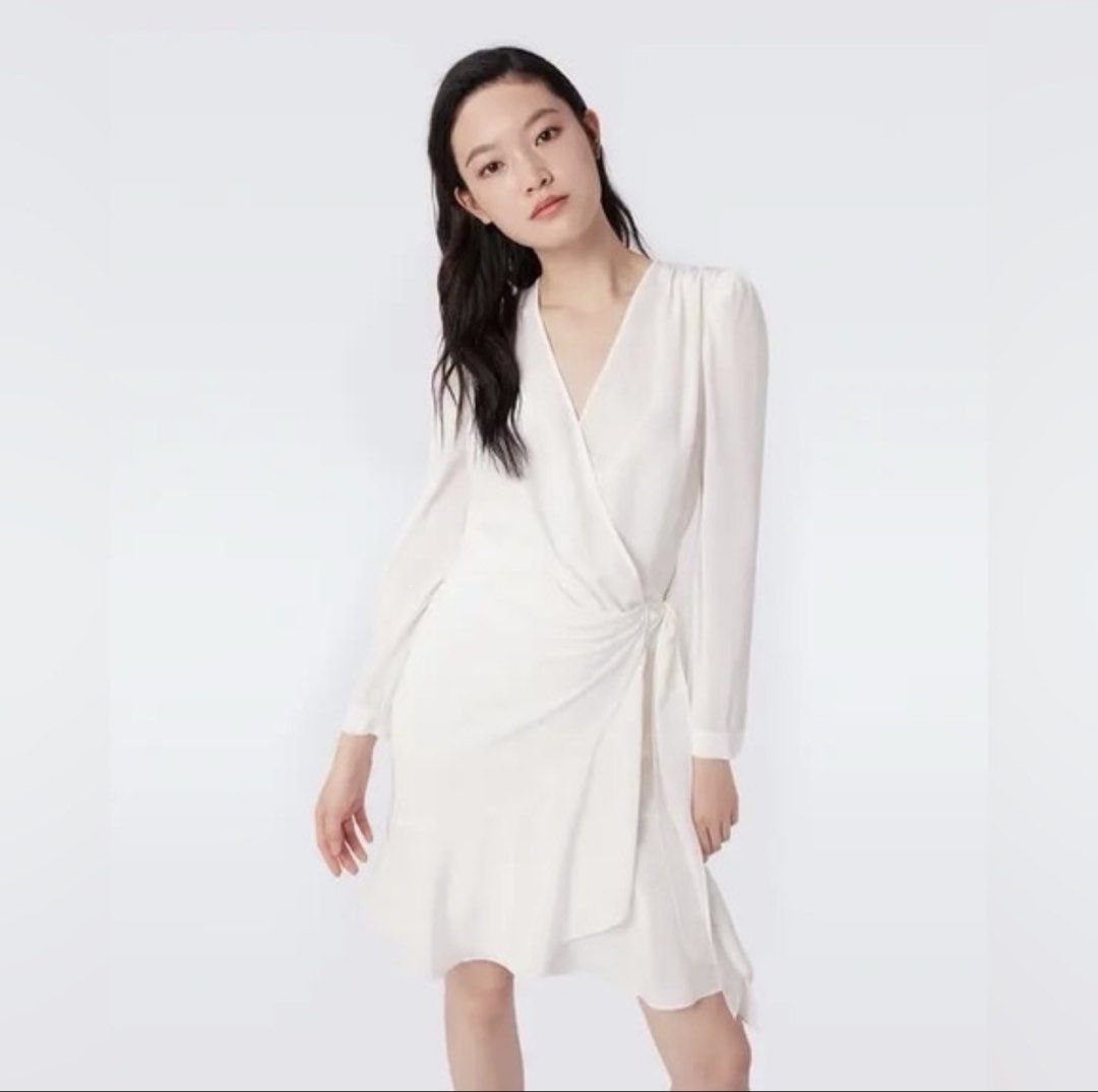 Pull & Bear White Wrap Dress (Category: Dresses) located in Apalit. Submitted by ic_declutter (Listing ID 1435596027, Image 1). Description: White wrap dress from Pull & Bear. Features a V-neckline and long sleeves. The dress has a tie detail at the waist and a flowing skirt. Made in Morocco. Size S/USA S/MEX 26..