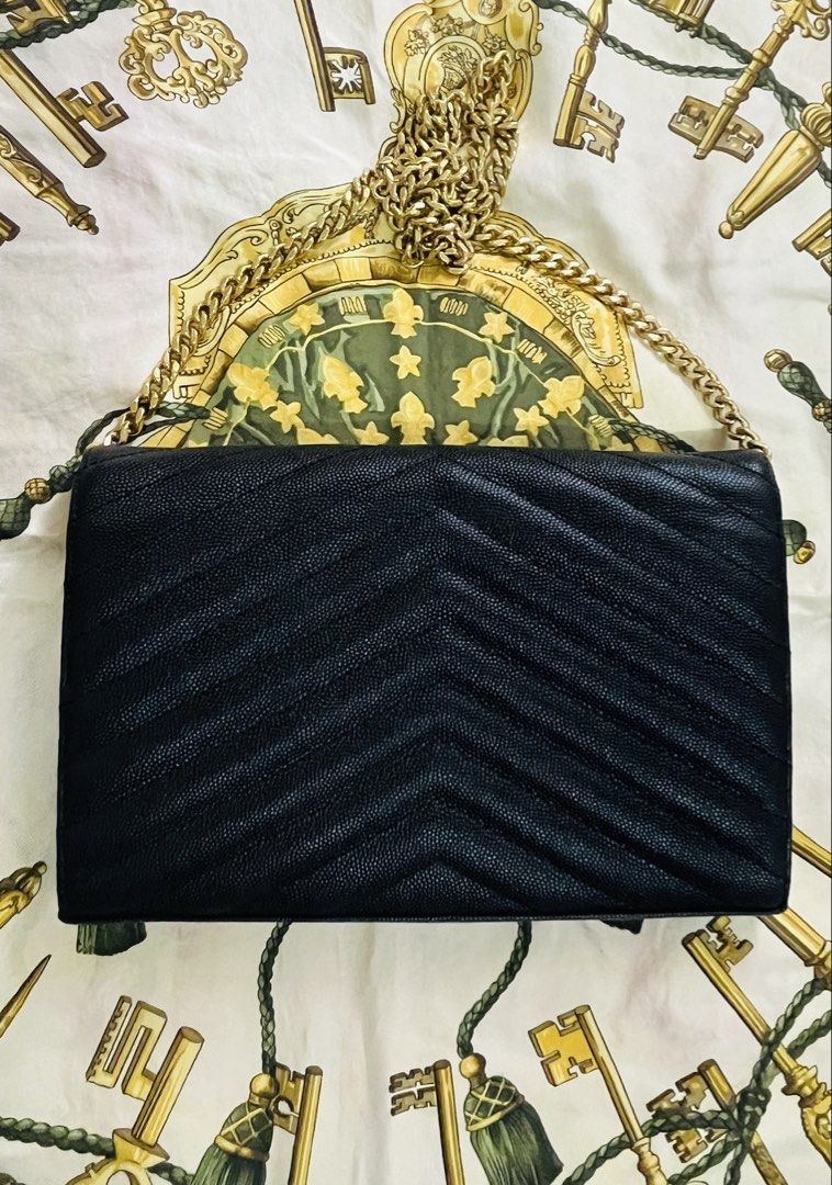 Saint Laurent Envelope Chain Wallet Bag (Category: Luxury Bags & Wallets) located in Iloilo. Submitted by yangfire (Listing ID 1435545577, Image 2). Description: - Saint Laurent Envelope Chain Wallet - Black with gold-tone hardware - Chevron-quilted design - Chain strap - Multiple card slots and zippered compartment - Saint Laurent logo on front This bag was given to me by a friend as payment... no inclusion... authenticity not gurantee... just l