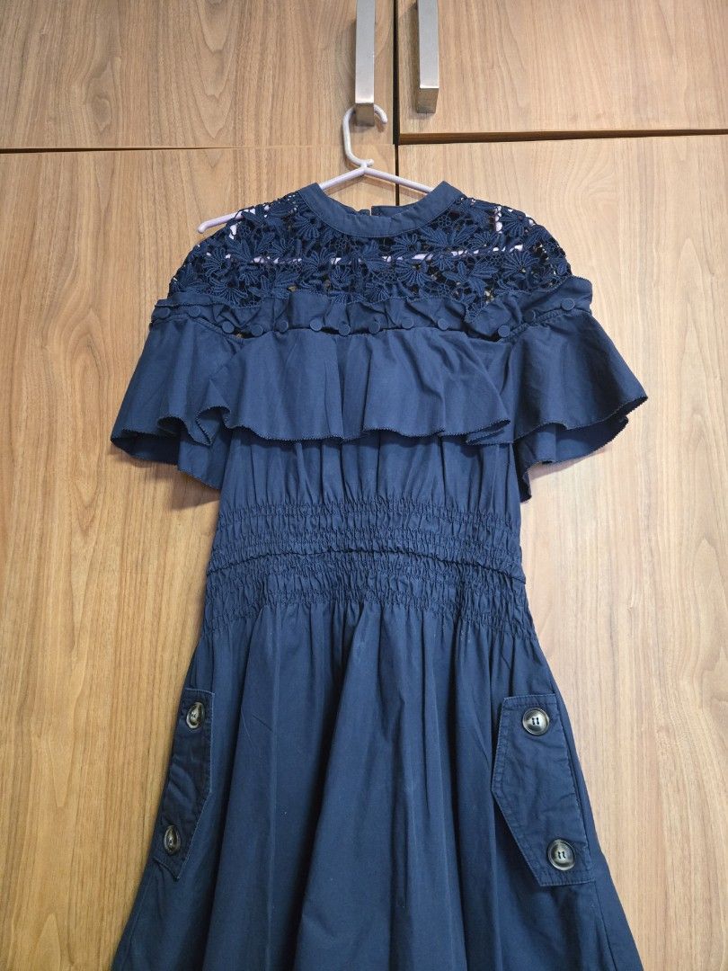 Self-Portrait Navy Dress (Category: Dresses) located in Pasig City. Submitted by izzy0202 (Listing ID 1435618612, Image 1). Description: - Self-Portrait navy dress - Features a lace bodice - Ruffled detailing - Fitted waist - Button details on the side - Short sleeves - UK size 6.