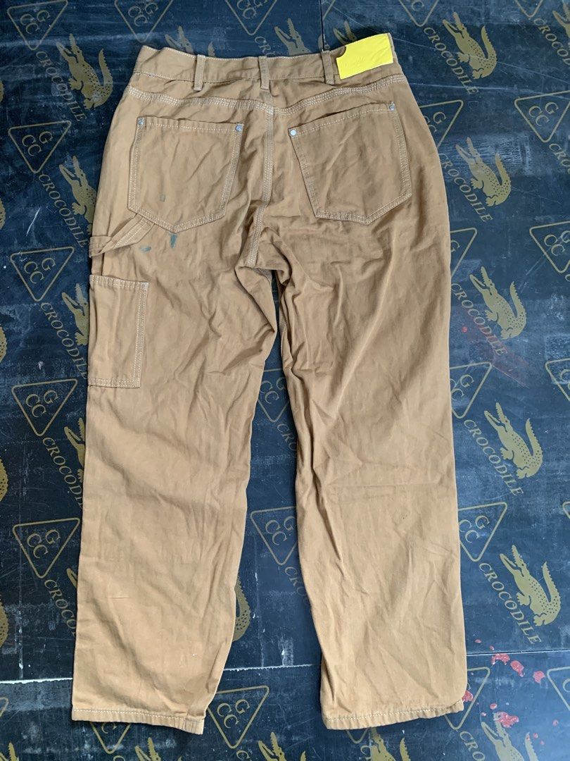 TBSM Trouble Smile Painter Pants (Category: Jeans) located in Baguio. Submitted by brix6699 (Listing ID 1435575866, Image 2). Description: - TBSM Trouble Smile painter pants - Color: Brown - Size: M - Paint splatter details on front - Multiple pockets - Yellow leather brand patch - Button closure with Trouble Smile logo - Two back pockets - Dimensions Length 37.5 inches Leg opening 8.5 inches Waist line 32 .