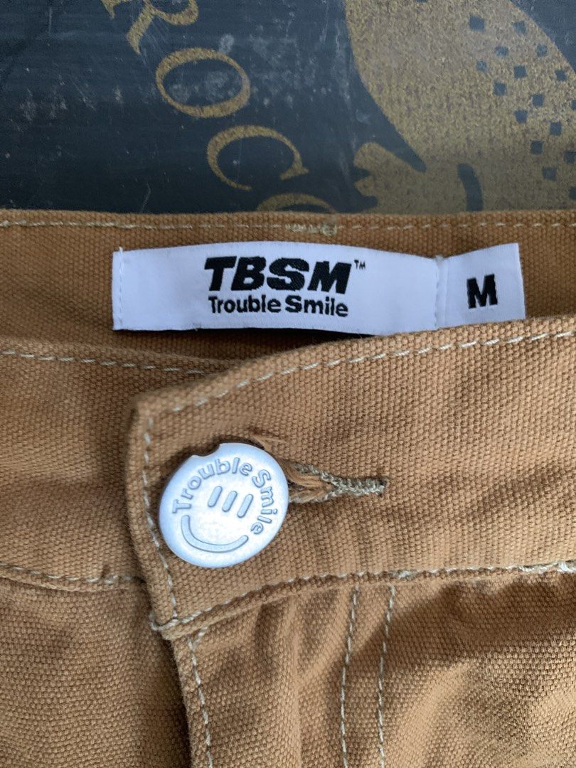 TBSM Trouble Smile Painter Pants (Category: Jeans) located in Baguio. Submitted by brix6699 (Listing ID 1435575866, Image 3). Description: - TBSM Trouble Smile painter pants - Color: Brown - Size: M - Paint splatter details on front - Multiple pockets - Yellow leather brand patch - Button closure with Trouble Smile logo - Two back pockets - Dimensions Length 37.5 inches Leg opening 8.5 inches Waist line 32 .