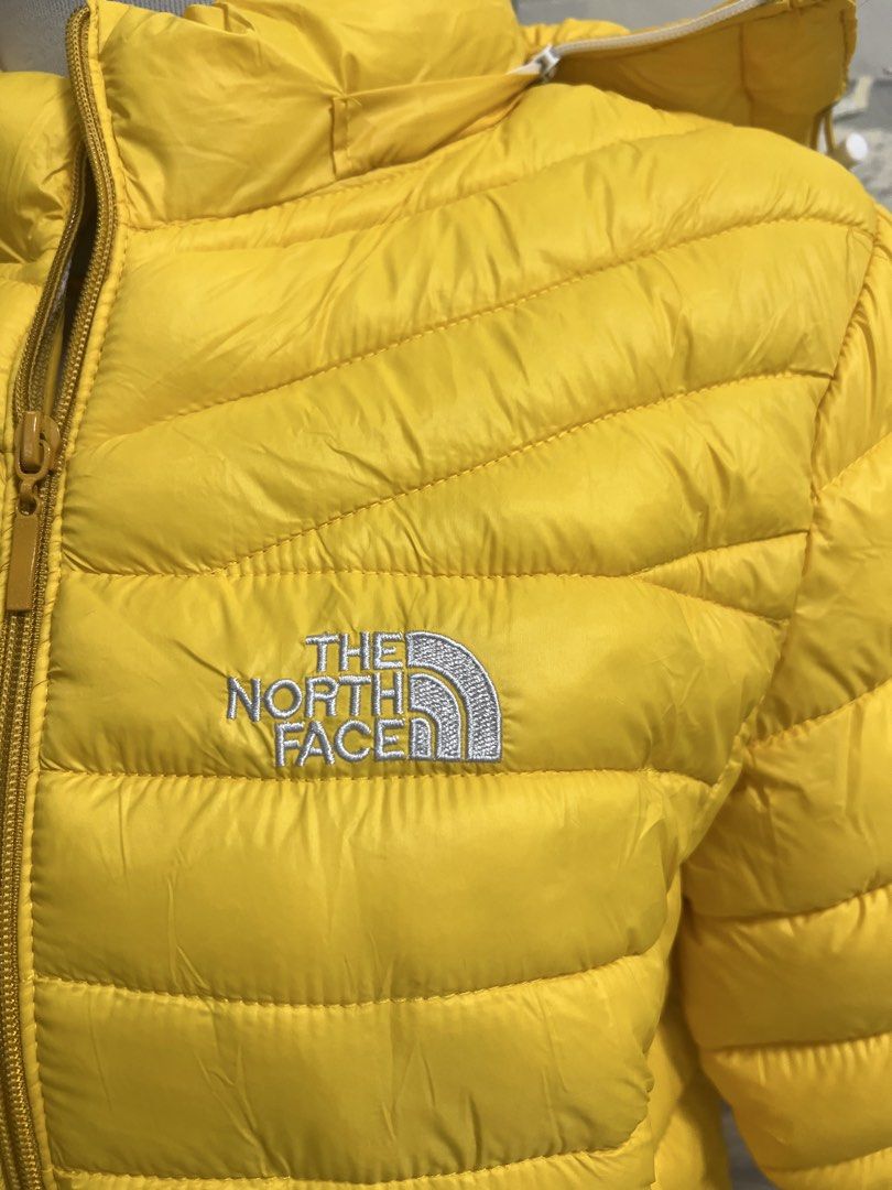 The North Face Yellow Puffer Jacket (Category: Coats, Jackets and Outerwear) located in Antipolo. Submitted by murapod2 (Listing ID 1435523730, Image 3). Description: Bright yellow puffer jacket from The North Face. Features a hood and a zip-up front. The North Face logo is visible on the chest. The jacket has "GORE-TEX Performance Shell" printed on the sleeve..