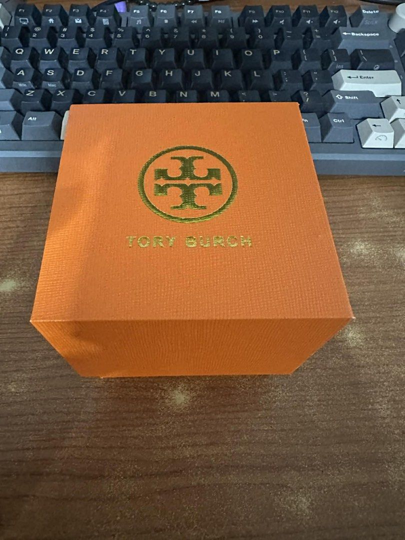 Tory Burch Watch (Category: Women's Watches) located in Quezon City. Submitted by raymonet (Listing ID 1435574626, Image 3). Description: - Tory Burch watch - Gold-tone bezel - Two-tone stainless steel band - Tory Burch logo on watch face - Includes original box and shopping bag - Perfect for any occasion.