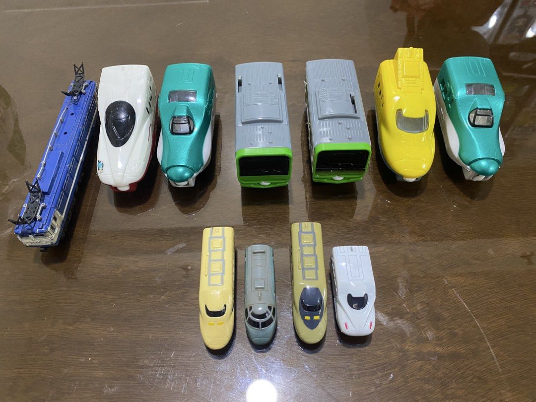Toy Train and Car Collection (Category: Vehicle & Diecast Models) located in Quezon City. Submitted by declutterthingzzz (Listing ID 1435712763, Image 2). Description: - Variety of toy train models in different colors and designs. - Some are from Mcdonalds - Includes a silver SUV. - Features a white sedan. - Also includes a dark purple minivan. - Ideal for collectors and kids who enjoy playing with toy vehicles. Price starts at 70.