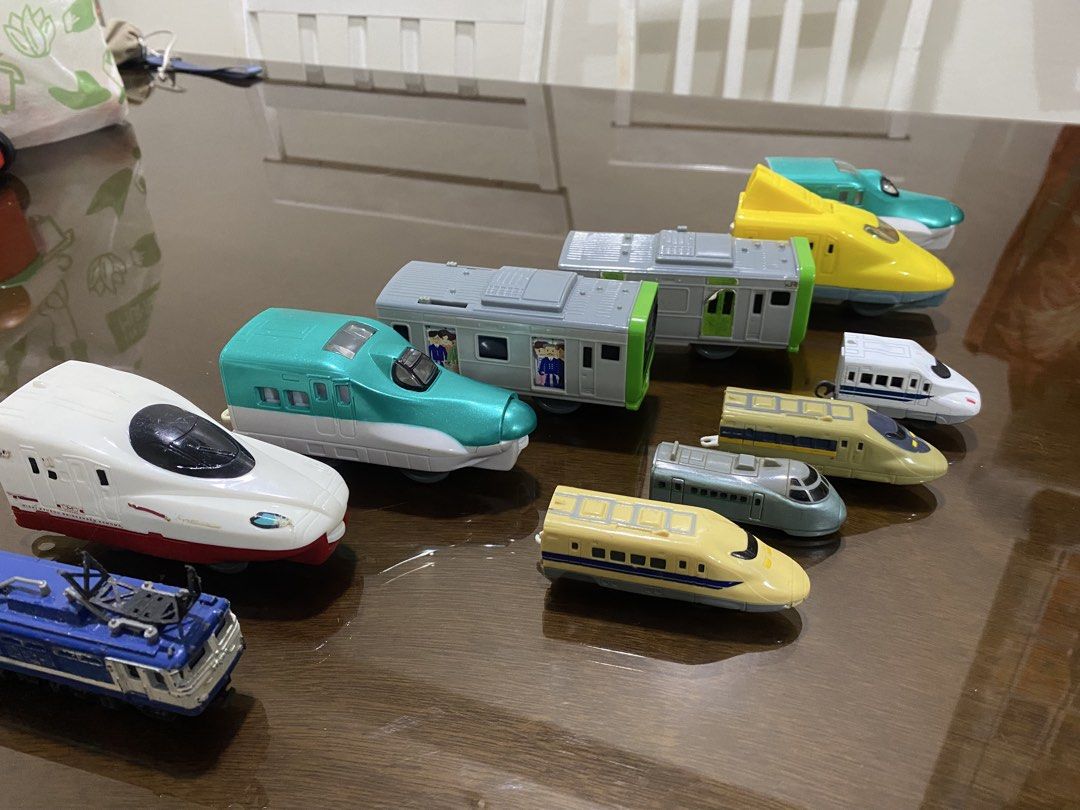 Toy Train and Car Collection (Category: Vehicle & Diecast Models) located in Quezon City. Submitted by declutterthingzzz (Listing ID 1435712763, Image 3). Description: - Variety of toy train models in different colors and designs. - Some are from Mcdonalds - Includes a silver SUV. - Features a white sedan. - Also includes a dark purple minivan. - Ideal for collectors and kids who enjoy playing with toy vehicles. Price starts at 70.