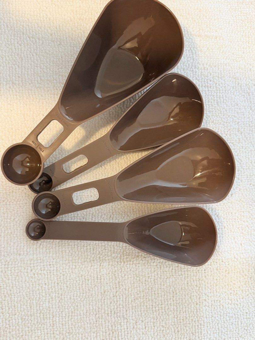 Tupperware Measuring Spoons Set (Category: Bakeware) located in Marikina City. Submitted by ukaiiukai (Listing ID 1435566099, Image 1). Description: - Tupperware measuring spoon set (4 spoons). - Brown color. - Sizes: 1/4 tsp, 1/2 tsp, 1 tsp, and 1 cup. - Durable plastic construction. - Long handles for easy scooping. - Hole for hanging storage..