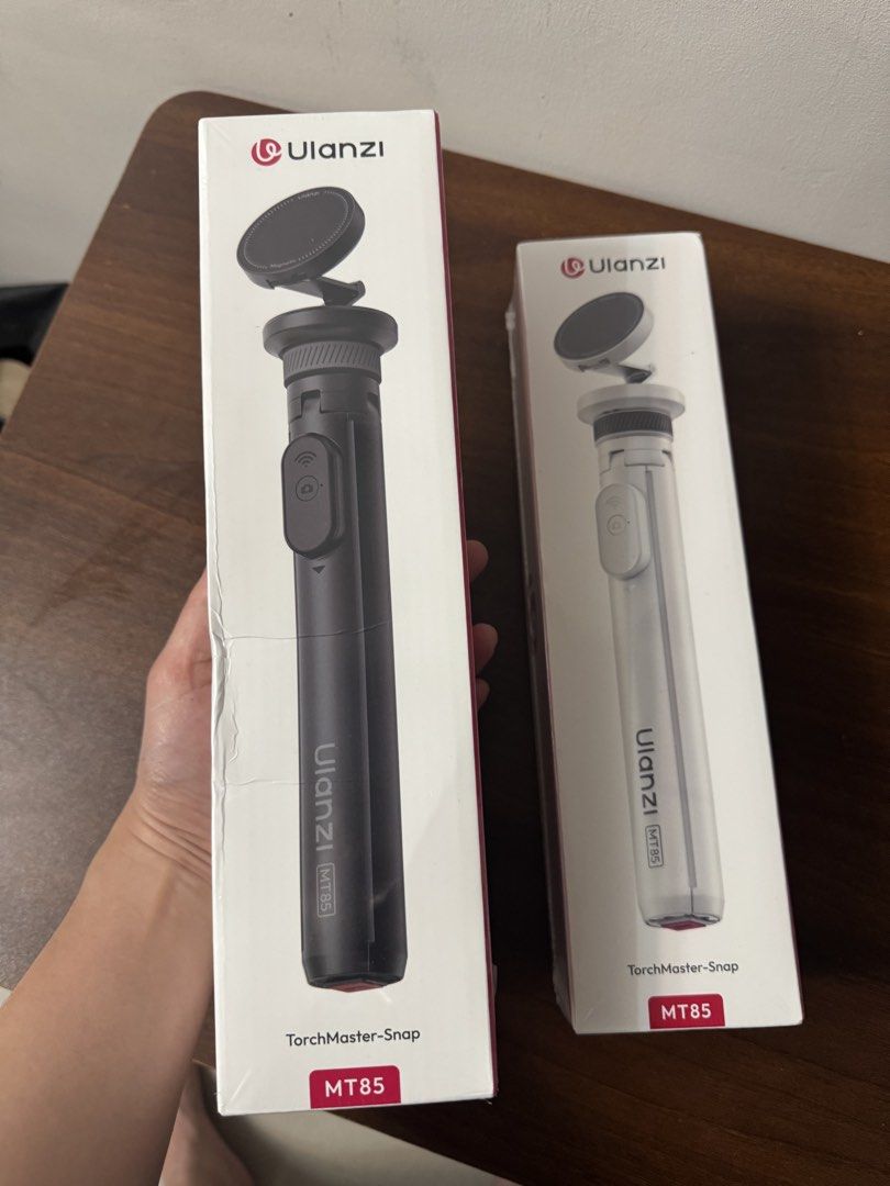Ulanzi MT85 TorchMaster-Snap Tripod (Category: Tripods & Monopods) located in Makati City. Submitted by itsjmla (Listing ID 1435554328, Image 2). Description: - Ulanzi MT85 TorchMaster-Snap Tripod - Features a magnetic phone mount - Includes a built-in remote control - Available in Black and White - Compact and portable design - Ideal for content creators and mobile photographers - Easy setup and use.