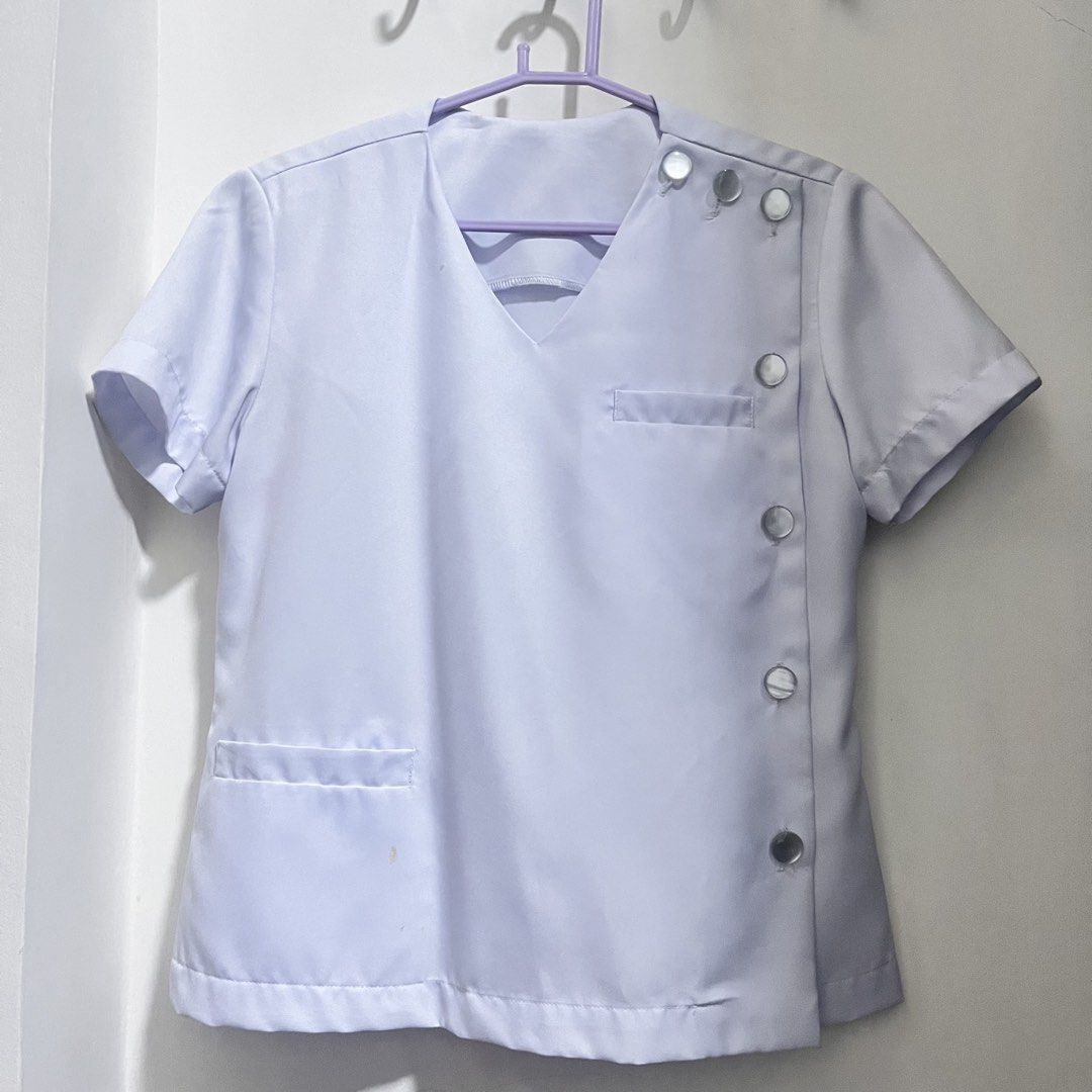 White Clinical Uniform - Womens (Category: Sets or Coordinates) located in Valenzuela. Submitted by 99jch (Listing ID 1435611382, Image 1). Description: - White uniform set (top and skirt) - Top features a V-neck design - Button details on the side of the top - Top includes a pocket - Simple, knee-length skirt - Minor stains present on the top Dm for more pics! FITS small to medium girlies! 📩.