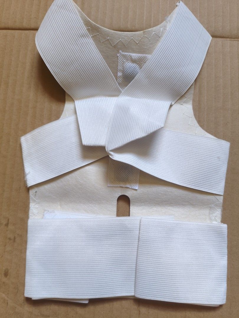 White Posture Corrector Back Brace (Category: Braces, Support & Protection) located in Pasig City. Submitted by coolphoenix-29ac (Listing ID 1435549539, Image 2). Description: - Adjustable straps for a customized fit - Vest-like design for comprehensive support - Made of soft, flexible material - Easy hook and loop closure - Designed to improve posture - Provides back support.