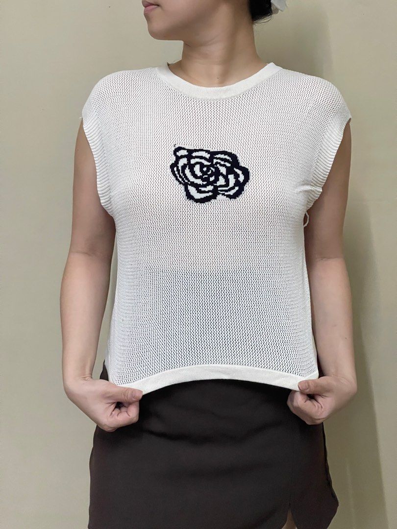 White Sleeveless Top with Rose Embroidery (Category: Sleeveless) located in Cavite. Submitted by ellanierva (Listing ID 1435553915, Image 1). Description: - White sleeveless top - Rose embroidery on front - Round neckline - Mesh-like knit - Small hole on the back - Neutral color - Small hole at the back as seen in the last photo.