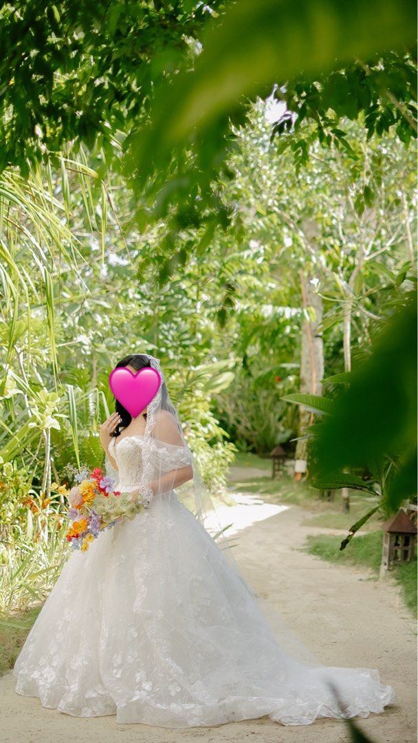 White wedding gown (Category: Dresses) located in Quezon City. Submitted by cabdeclutters (Listing ID 1435677842, Image 2). Description: Worn last Dec 2025. Bought for 25k. It was worn for an island wedding thats why it needs cleaning. Im a medium frame pero the size of the gown is for Small to Large frame adjustable po yung likod. .