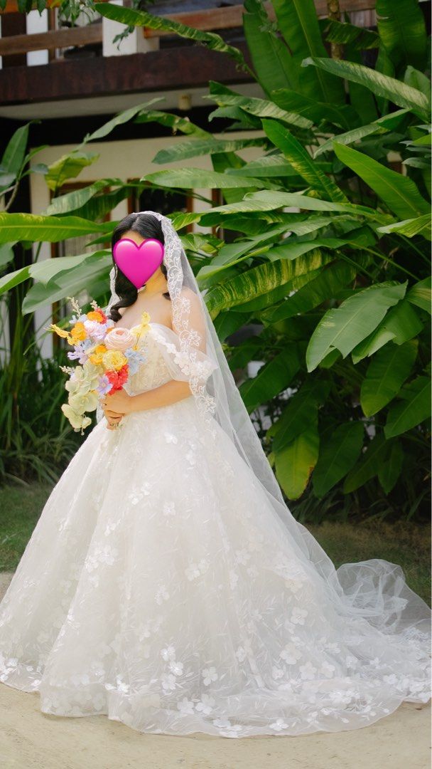 White wedding gown (Category: Dresses) located in Quezon City. Submitted by cabdeclutters (Listing ID 1435677842, Image 1). Description: Worn last Dec 2025. Bought for 25k. It was worn for an island wedding thats why it needs cleaning. Im a medium frame pero the size of the gown is for Small to Large frame adjustable po yung likod. .