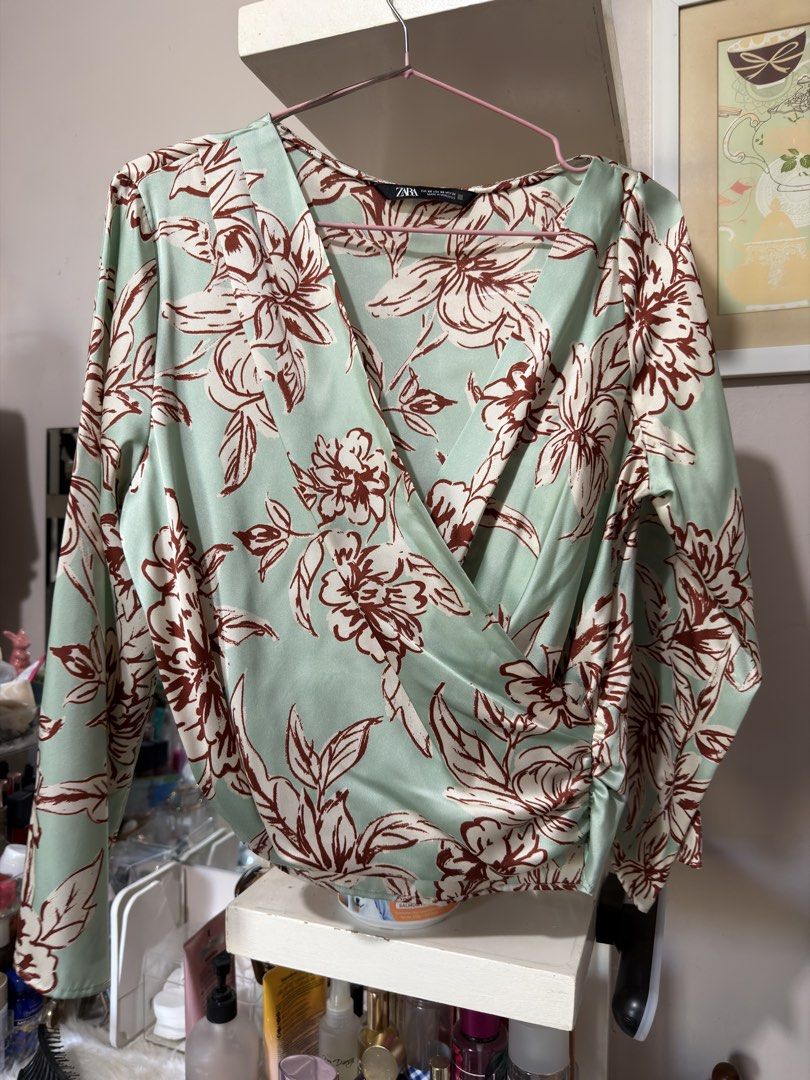 Zara Floral Wrap Blouse (Category: Blouses) located in Apalit. Submitted by ic_declutter (Listing ID 1435602237, Image 2). Description: - Zara wrap blouse - Floral print in green, red, and white - Long sleeves - Flattering V-neck - Size: XS - Made in Morocco.
