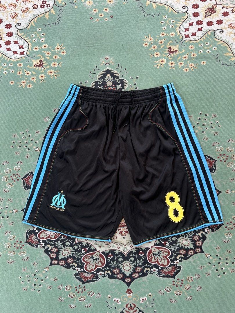 05-06 Adidas Olympique Marseille (Category: Shorts) located in Angeles City. Submitted by outboxph (Listing ID 1439022840, Image 2). Description: CODE: ML36 05-06 A.d.i.d.a.s. Olympique Marseille Track Shorts Authentic/Legit with tag and wash tag Size: Medium on tag Dimensions: 26-32 waist x 17L Rise: 12.5 inches Thigh Measurement: 13 inches Inseam: 7 inches Leg Opening: 11 inches Condition: 9/10 With drawstring 450 plus shipping fee .