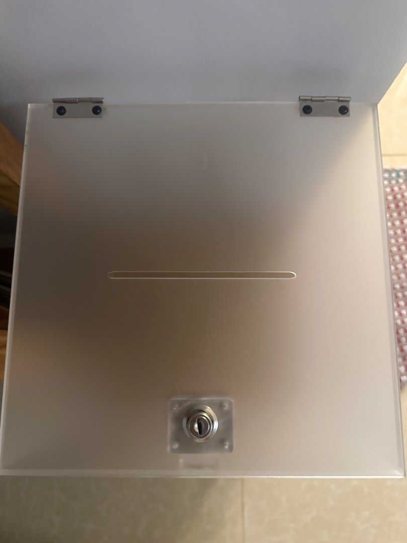 Acrylic Box with Lock used once for wedding (Category: Storage Boxes & Baskets) located in Manila. Submitted by cosmichorse_d0ad24 (Listing ID 1438880875, Image 1). Description: - Acrylic donation box - Frosted finish - Features a slot and secure lock - Personalized with: 'Desiree and KD','01.15.2026', and 'The Glass Tower, Tagaytay' (EASY TO REMOVE) - Ideal for various events.