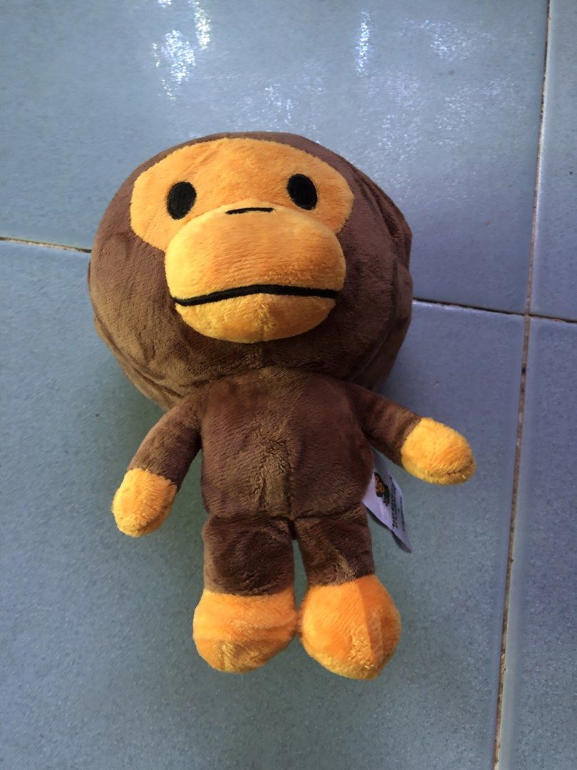 BAPE x Starbucks Monkey Plush Toy with Bag (Category: Plushies & Soft Toys) located in Montevista. Submitted by rdthriftshub (Listing ID 1438942130, Image 3). Description: - Authentic BAPE x Starbucks monkey plush toy - Comes with a matching patterned bag - Plush features a brown monkey with orange accents - Includes original tag - Bag features a colorful pattern - Plush toy can be stored inside the bag.