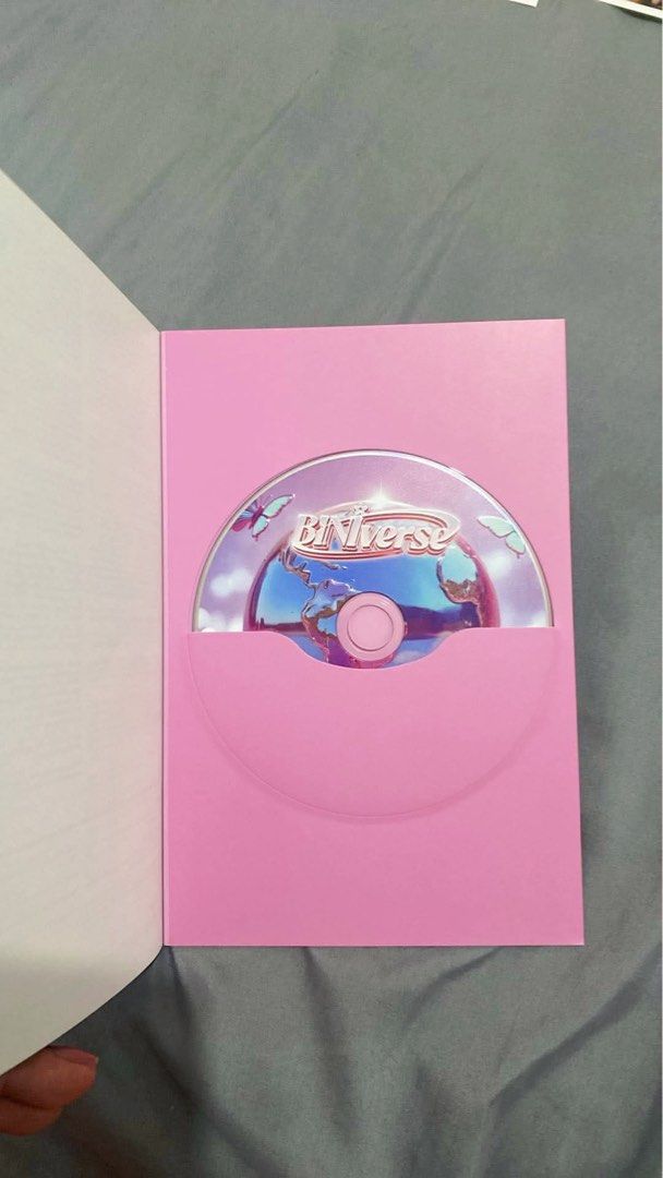 BINI - Biniverse Album (Category: CDs & DVDs) located in Angono. Submitted by arlohaze (Listing ID 1438991604, Image 2). Description: - BINI BUniverse album - Includes: Album and stickers - Features a pink CD case - Cover art showcases BINI members and album title.