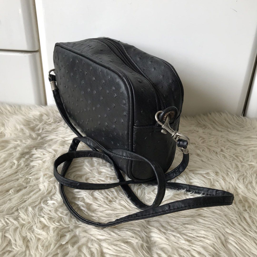 Black Ostrich-Embossed Crossbody Bag (Category: Cross-body Bags) located in Baao. Submitted by all.things.japan (Listing ID 1438985271, Image 2). Description: - 8.0 x 2.25 x 5.25 inches - Black crossbody bag - Ostrich-embossed texture - Zippered closure - Adjustable long strap - Silver-toned hardware - Made of leather - Rectangular shape.