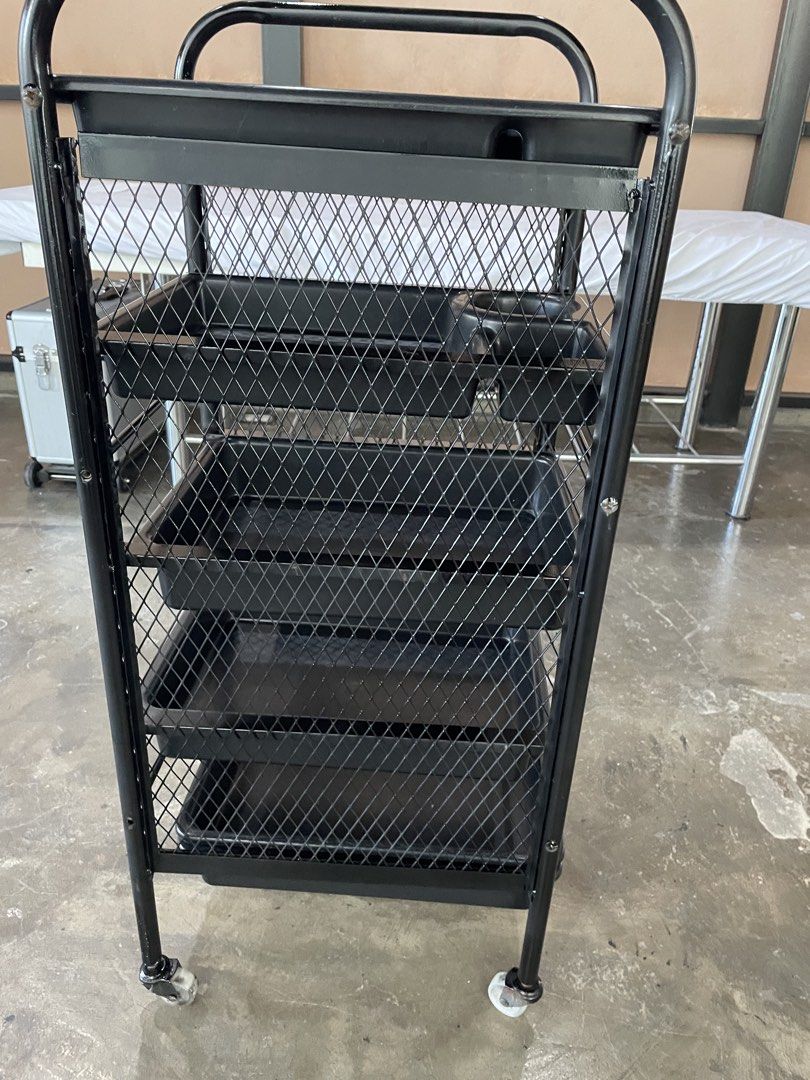 Black Salon Cart with Trays (Category: Office Furniture & Fixtures) located in Santa Rosa. Submitted by emelyn71 (Listing ID 1438925579, Image 3). Description: - Black salon cart - Multiple trays for storage and organization - Sturdy metal frame with mesh design - Includes tray with cup holder and compartments - Designed with wheels for easy mobility - Ideal for salons or organized storage needs.