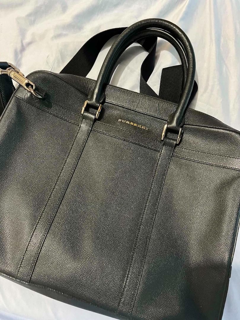 Burberry Leather Briefcase Bag (Category: Luxury Bags & Wallets) located in Quezon City. Submitted by babybomber69 (Listing ID 1438891280, Image 1). Description: - Authentic Burberry tote bag - Black exterior - Zipper closure - Plaid interior lining - Multiple pockets for organization - Includes dust bag.