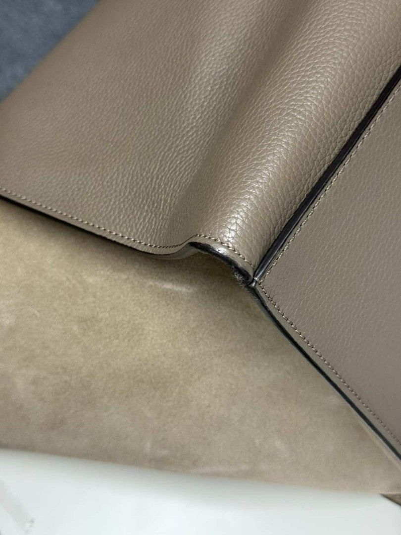 Celine Trapeze Handbag (Category: Luxury Bags & Wallets) located in Paranaque City. Submitted by 606wuwtrading (Listing ID 1438995228, Image 3). Description: Large Celine Trapeze handbag in a neutral color. Features a flap closure, top handle, and back zipper pocket. Made with leather and suede. Sourced in Japan.