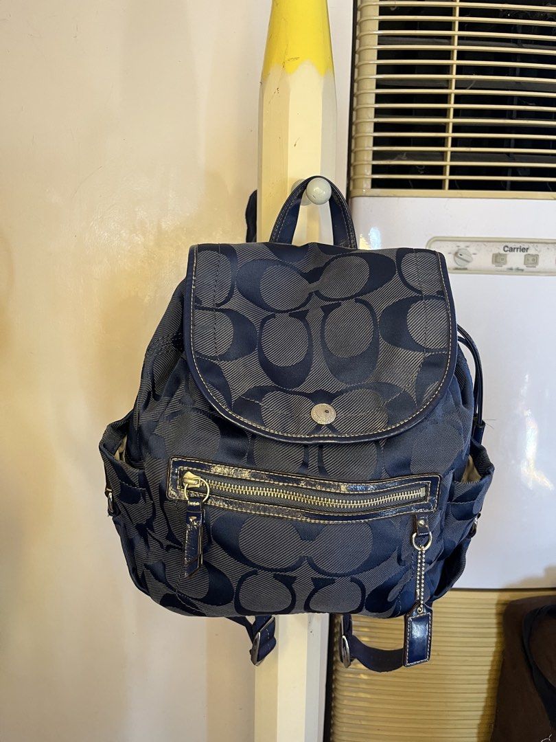 Coach Signature Backpack (Category: Luxury Bags & Wallets) located in Calamba. Submitted by vtg_ukay_bags (Listing ID 1438909502, Image 2). Description: - Authentic Coach backpack - Navy blue with signature Coach pattern - Flap closure with silver-tone button - Zippered front pocket - Side pockets - Adjustable straps - Top handle - Coach tag attached.