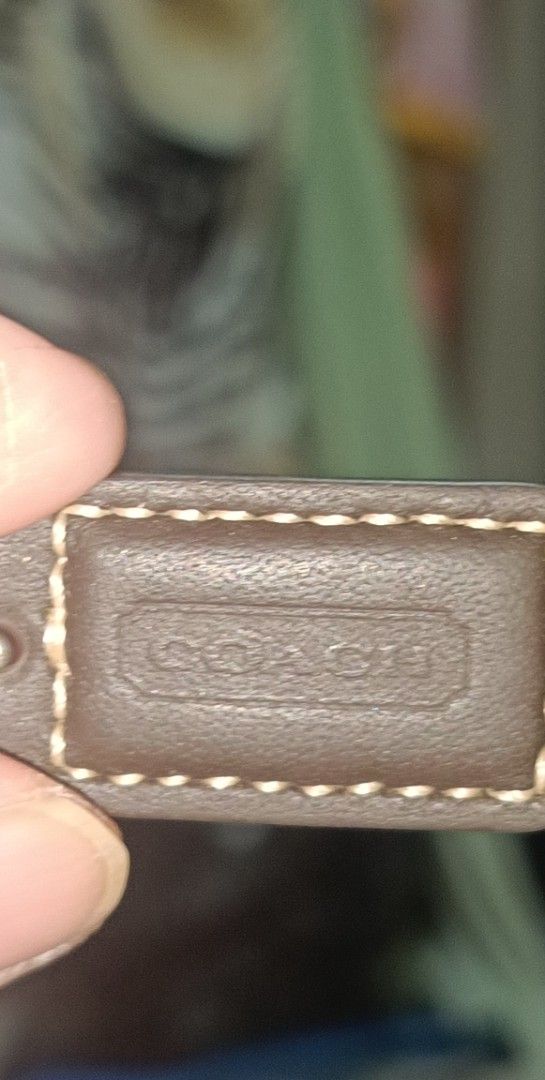 vintage Coach Wristlet (Category: Luxury Bags & Wallets) located in Famy. Submitted by ljcastejon (Listing ID 1438945177, Image 3). Description: - vintage Coach wristlet - Signature print design - Features a brown leather wrist strap - Secure zip closure - Includes Coach logo patch - Compact size, ideal for essentials.