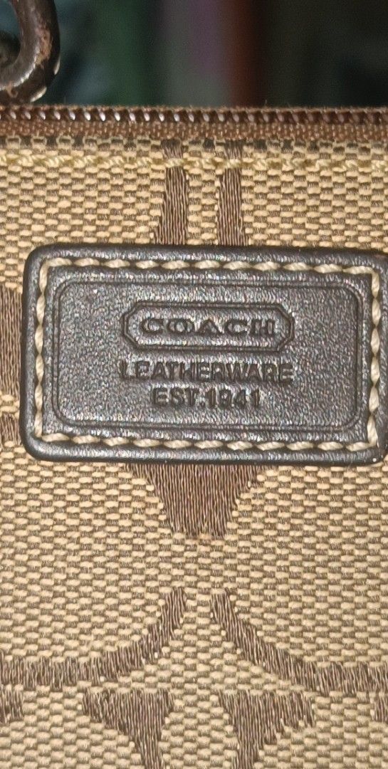 vintage Coach Wristlet (Category: Luxury Bags & Wallets) located in Famy. Submitted by ljcastejon (Listing ID 1438945177, Image 2). Description: - vintage Coach wristlet - Signature print design - Features a brown leather wrist strap - Secure zip closure - Includes Coach logo patch - Compact size, ideal for essentials.