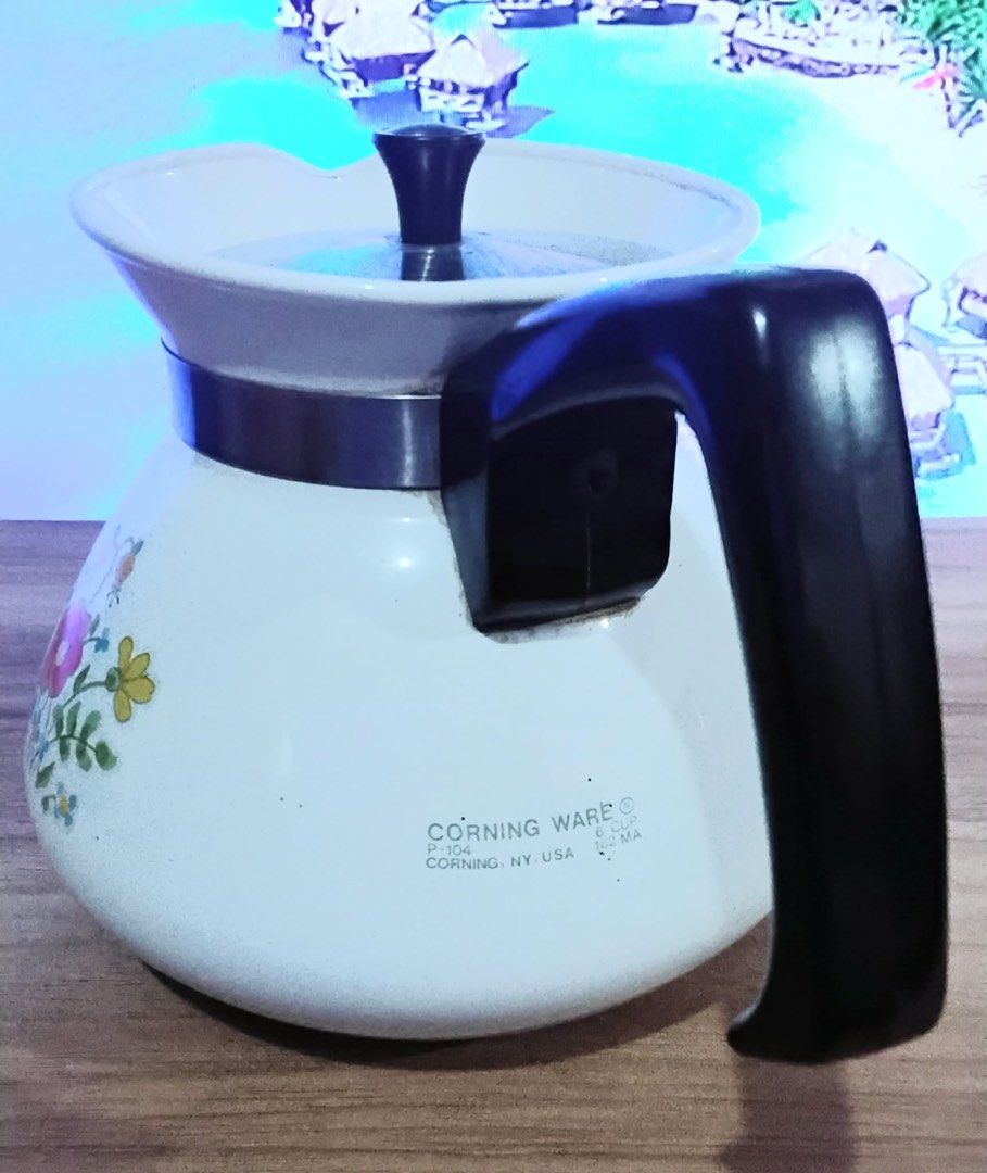 Vintage Corningware Floral Tea Pot (6Cups) (Category: Coffee & Tea Tableware) located in Quezon City. Submitted by unique_vintage_shop (Listing ID 1438897622, Image 2). Description: P1300 This is a vintage Corning Ware P-104 6-cup teapot/kettle featuring the “Wildflower” pattern. Pattern: The “Wildflower” design, introduced in the 1970s, features orange, yellow, and blue flowers with a butterfly. Material: The pot is made of Corning Ware’s durabl