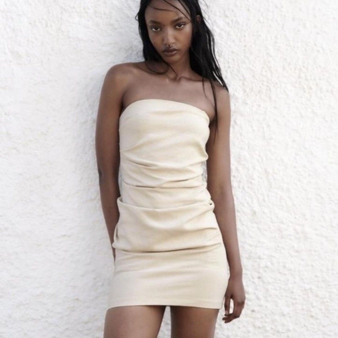 Zara Cream Strapless Dress - Size M (Category: Dresses) located in Dolores. Submitted by harleyquinn819 (Listing ID 1438361722, Image 1). Description: - Last price - Cream-colored strapless dress - Ruched bodice - Straight, fitted skirt - Zipper closure at the back - Lightweight fabric - Suitable for warmer weather - Simple, elegant design.
