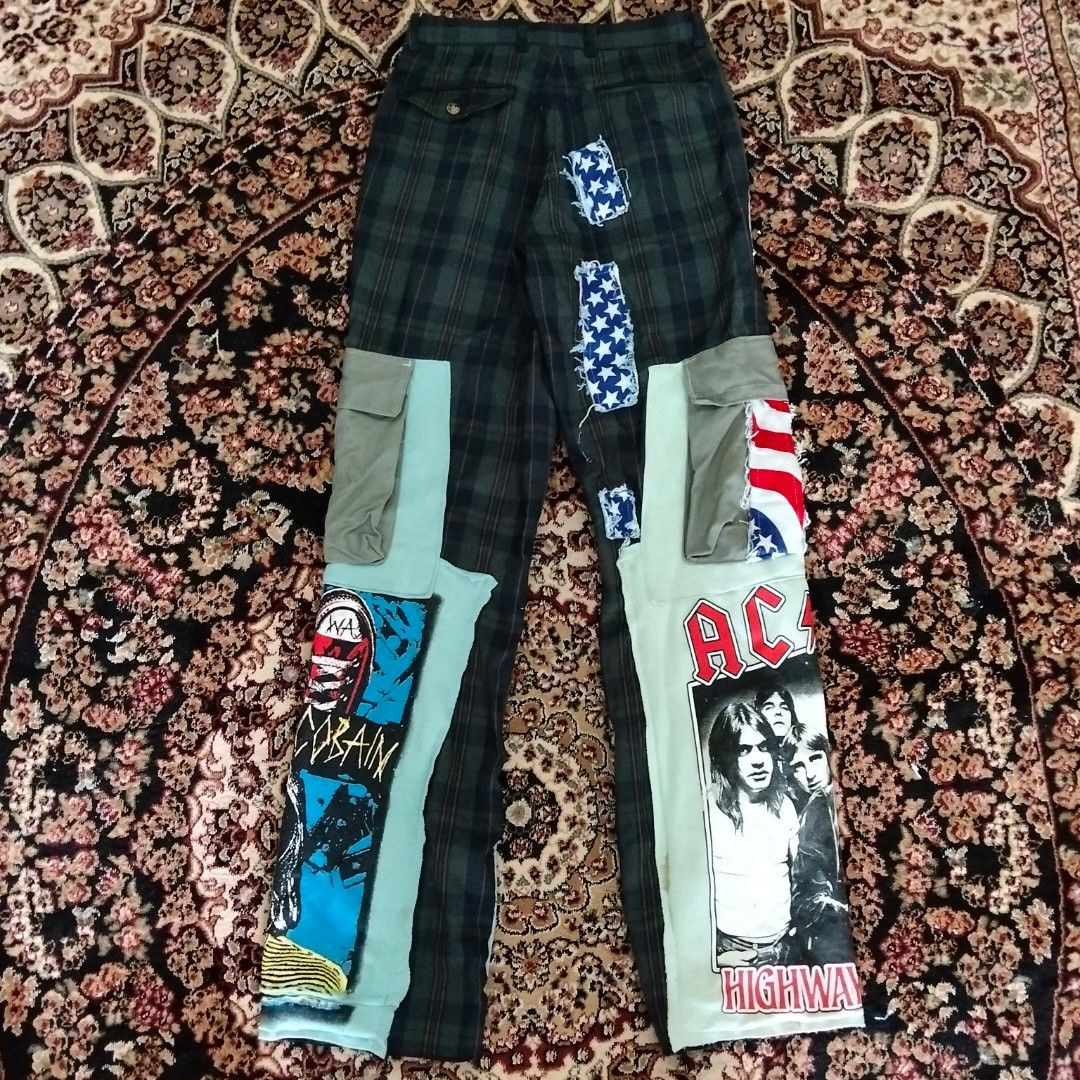 Custom Patchwork Plaid Pants (Category: Trousers) located in Besut. Submitted by fiercedog_72f048 (Listing ID 1438995335, Image 2). Description: - Custom patchwork pants - Features AC/DC and Kurt Cobain graphics - Plaid pattern with multiple patches - Drawstring waist - Pockets with paisley detailing - Unique, custom design.