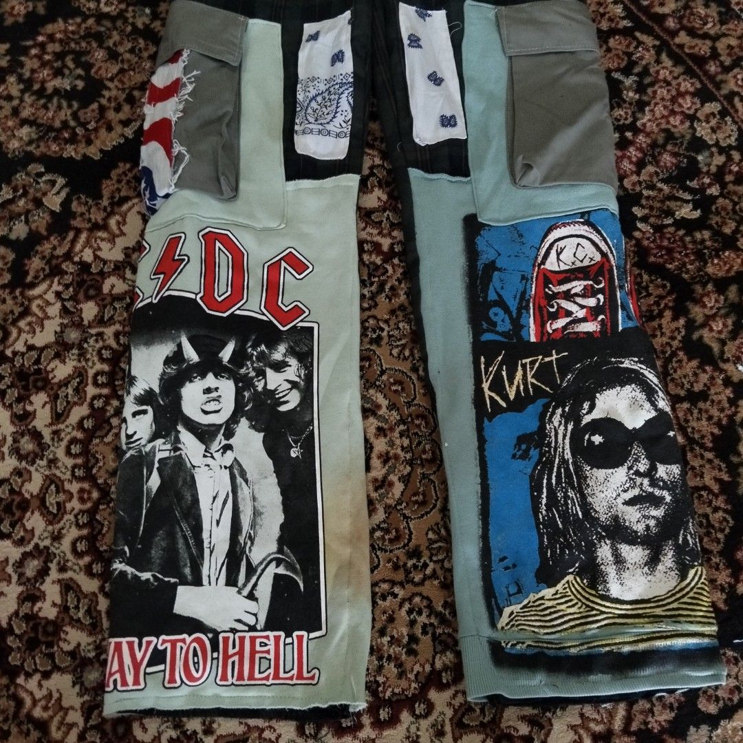 Custom Patchwork Plaid Pants (Category: Trousers) located in Besut. Submitted by fiercedog_72f048 (Listing ID 1438995335, Image 3). Description: - Custom patchwork pants - Features AC/DC and Kurt Cobain graphics - Plaid pattern with multiple patches - Drawstring waist - Pockets with paisley detailing - Unique, custom design.
