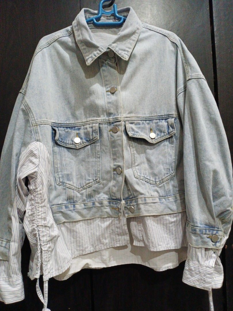Denim Jacket with Striped Shirt Detail (Category: Coats, Jackets and Outerwear) located in Manila. Submitted by ggarage.sale (Listing ID 1439062106, Image 1). Description: - Stylish light blue denim jacket - Unique design with striped shirt detail at bottom and sleeves - Two front pockets - Button closures - Gathered sleeve detail - Perfect for adding flair.