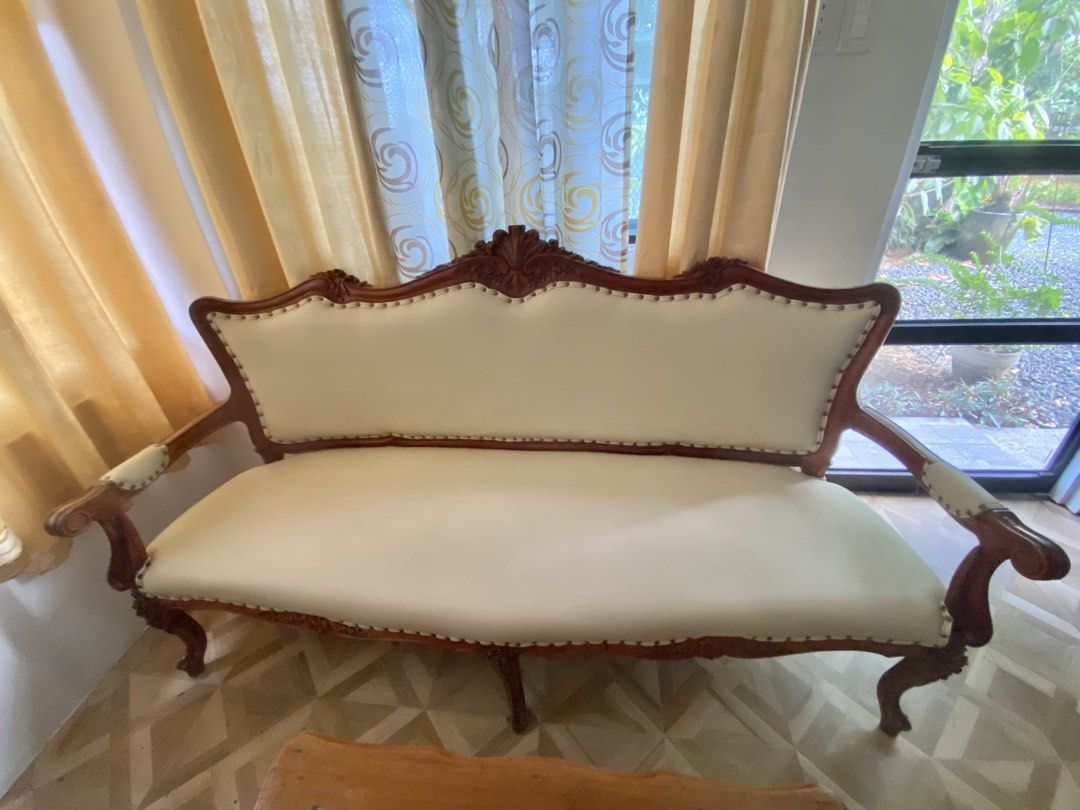 Elegant Solid Narra Sofa Set (Category: Sofas) located in Taguig. Submitted by ellajoy202 (Listing ID 1438959219, Image 2). Description: Designed with intricate hand-carved details and upholstered in premium cream leather, this classic furniture set offers both durability and sophistication. Includes: • 1 Three-seater sofa • 2 Accent armchairs • 1 Glass-top center table Features: • Crafted from authentic solid narra wood — durable, elegant, and b