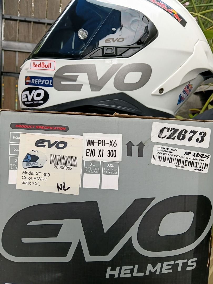 EVO XT 300 Motorcycle Helmet - White (Category: Helmets and other Riding Gears) located in Manila. Submitted by smnthdb97 (Listing ID 1438950040, Image 3). Description: - EVO XT 300 motorcycle helmet - Color: White - Visor: Dark - Decals: Red Bull and Repsol - Size: XXL - Model: WM-PH-X6 - Includes original box - Condition: slightly used once. Good as new.