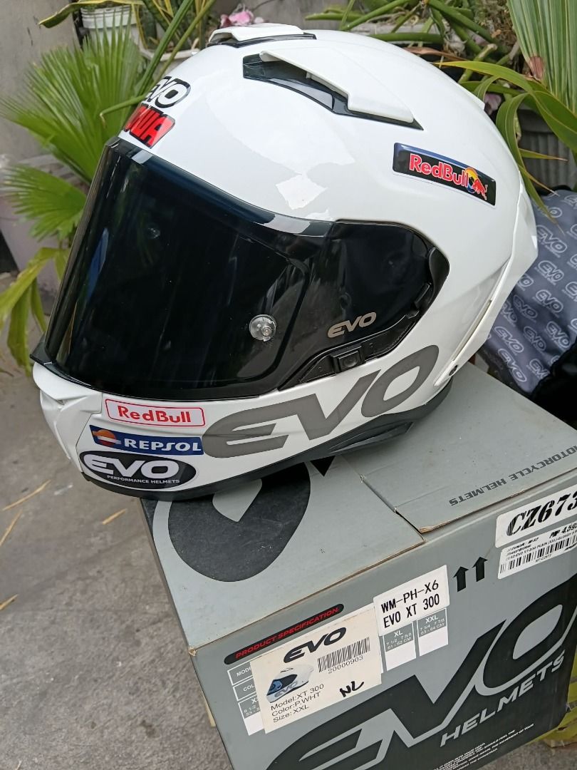 EVO XT 300 Motorcycle Helmet - White (Category: Helmets and other Riding Gears) located in Manila. Submitted by smnthdb97 (Listing ID 1438950040, Image 2). Description: - EVO XT 300 motorcycle helmet - Color: White - Visor: Dark - Decals: Red Bull and Repsol - Size: XXL - Model: WM-PH-X6 - Includes original box - Condition: slightly used once. Good as new.