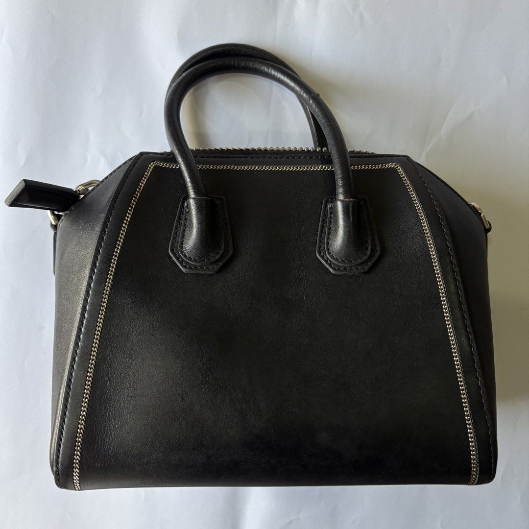 Givenchy Black Leather Mini Chain Embellished Antigona (Category: Luxury Bags & Wallets) located in Manila. Submitted by wintermelonmilktea2003 (Listing ID 1438981867, Image 2). Description: - Givenchy Antigona Mini Bag - Color: Black - Style: Mini - Features: - Top handle - Detachable shoulder strap - Silver-tone hardware - Zip closure - Material: 100% Calf Leather - Includes original tag.