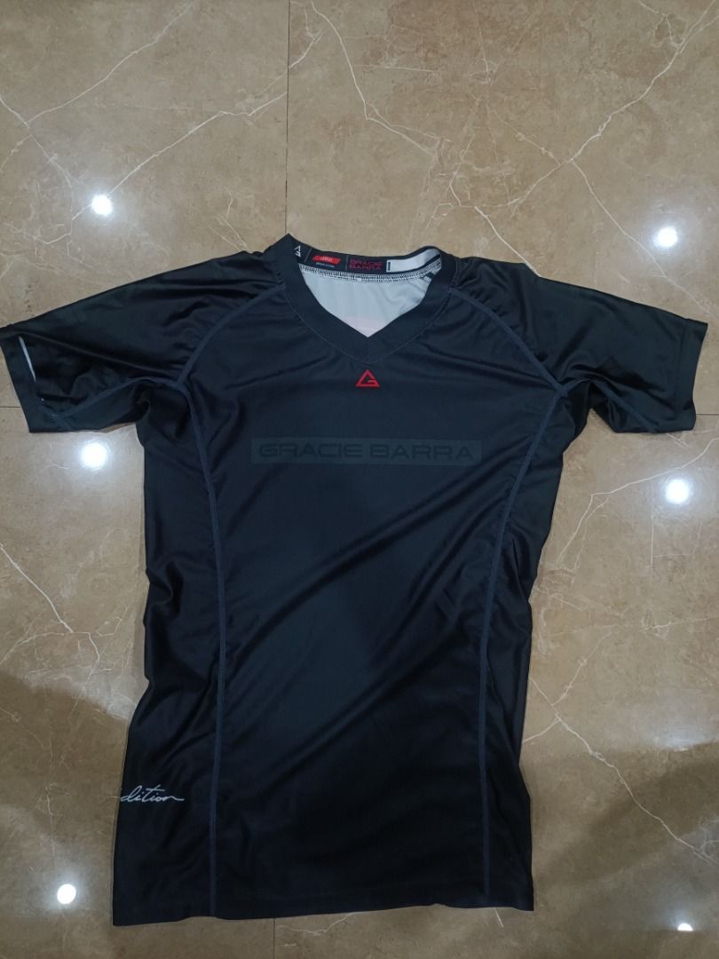 Gracie Barra Rashguard - Black (Category: Rash guard) located in Batac City. Submitted by yellowstone_1012 (Listing ID 1439036966, Image 2). Description: - Gracie Barra rashguard in black - Size: Large - Features Gracie Barra logo (front and back) - V-neck design - Short sleeves - Fitted athletic design.