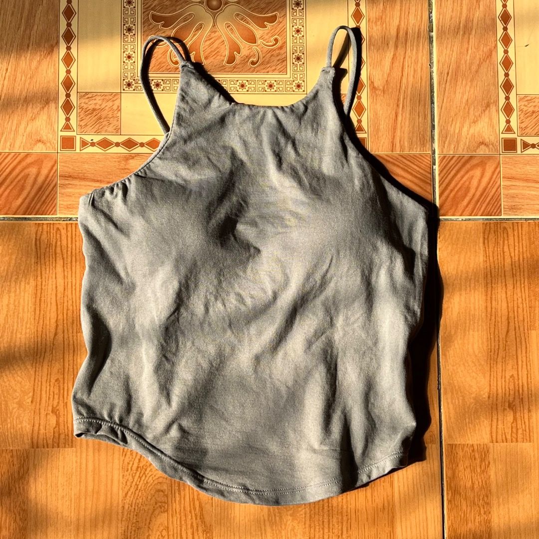 Gray Halter Tank Top (Category: Sleeveless) located in Caloocan City. Submitted by cabinetni_sam (Listing ID 1438993520, Image 1). Description: - Gray tank top - Scoop neckline - Thin straps - Unique back design - Soft, stretchy fabric - Great for layering or wearing alone - A versatile wardrobe essential.