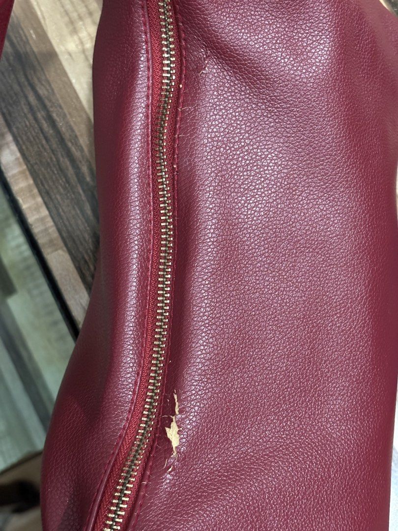GVN Hobo Bag - Burgundy small size (Category: Shoulder Bags) located in Mandaue City. Submitted by denden22222 (Listing ID 1438973433, Image 3). Description: - Burgundy hobo bag by GVN - Single shoulder strap - Gold-toned zipper - Gold-toned metal accent - Pebbled texture - Minor wear and tear near the zipper.