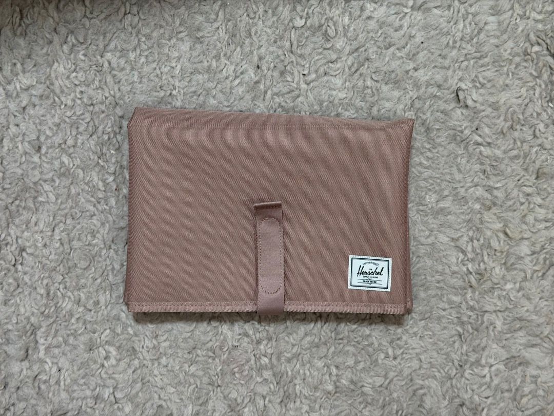 Herschel Changing Mat (Category: Changing Mats & Accessories) located in Manila. Submitted by creamsandnudes (Listing ID 1438995437, Image 1). Description: - Herschel changing mat for convenient diaper changes. - Soft, padded interior for baby's comfort. - Features the inspiring message "THE FUTURE IS YOURS." - Folds compactly and secures with a strap. - Stylish and practical for parents. - Neutral color suitable for any baby..
