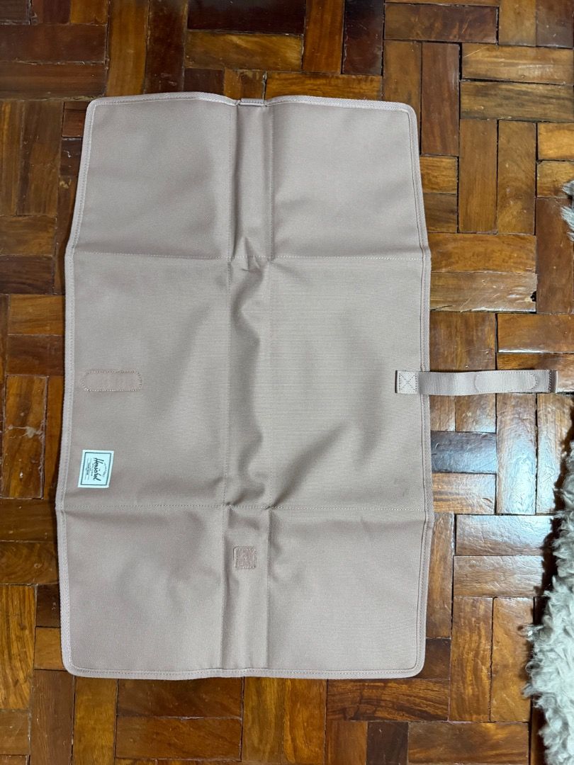 Herschel Changing Mat (Category: Changing Mats & Accessories) located in Manila. Submitted by creamsandnudes (Listing ID 1438995437, Image 2). Description: - Herschel changing mat for convenient diaper changes. - Soft, padded interior for baby's comfort. - Features the inspiring message "THE FUTURE IS YOURS." - Folds compactly and secures with a strap. - Stylish and practical for parents. - Neutral color suitable for any baby..