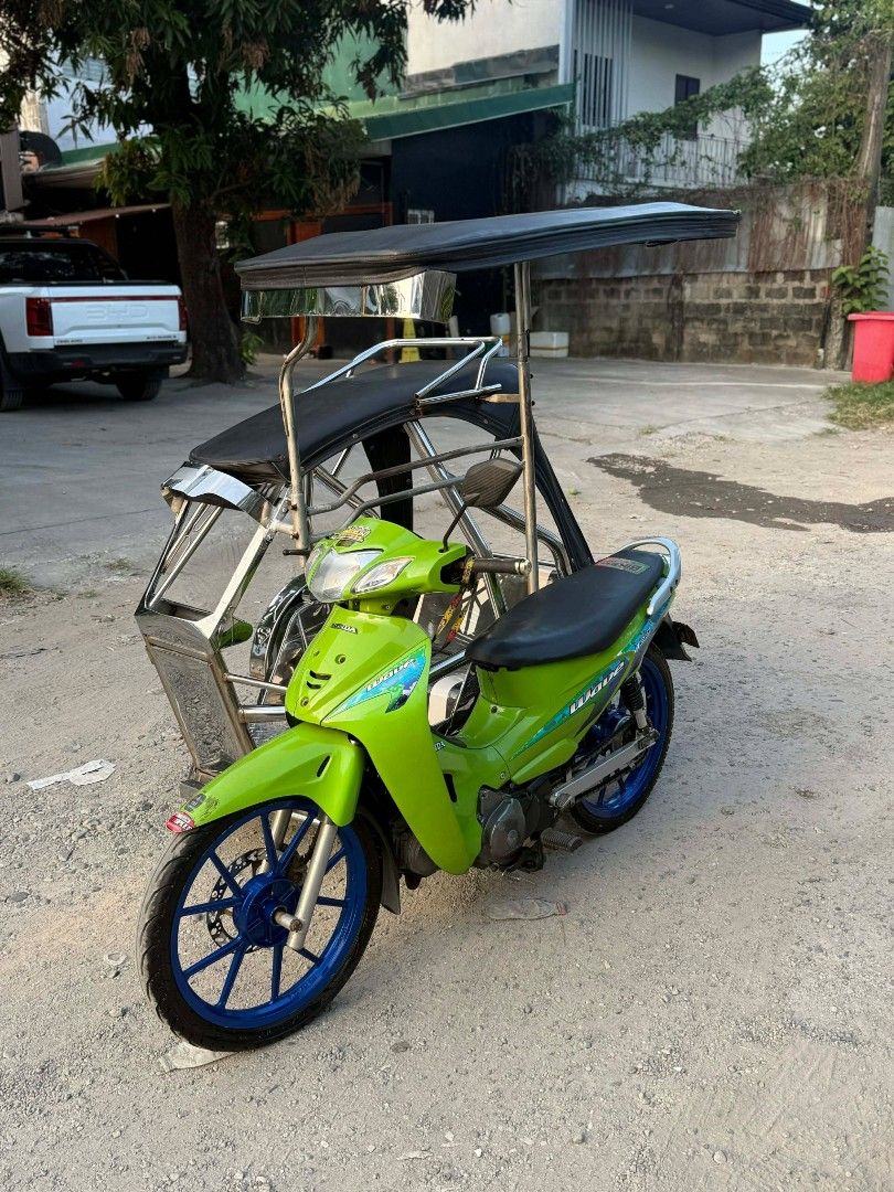 Honda Wave 125 Motorcycle with Sidecar (Category: Motorbikes for Sale) located in Balanga. Submitted by bravereender (Listing ID 1438898885, Image 2). Description: FOR SALE: Honda Wave 125 (2005) w/ Sidecar ✅ Complete Legal Papers ✅ Stock Engine ✅ 1st Owner (Acquired Unit) ✅ Tulisan Setup ✅ Volvo Stainless Sidecar 🤙 ✅ Daytona Mags ✅ Bago ang mga Gulong ✅ Tipid sa Gas 👌 📍 Location: San Jose, Balanga City, Bataan 📞 Contact: 0946 133 5509.