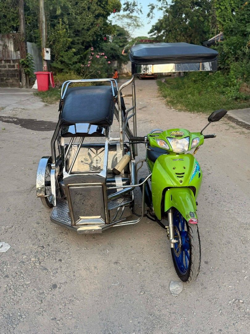 Honda Wave 125 Motorcycle with Sidecar (Category: Motorbikes for Sale) located in Balanga. Submitted by bravereender (Listing ID 1438898885, Image 1). Description: FOR SALE: Honda Wave 125 (2005) w/ Sidecar ✅ Complete Legal Papers ✅ Stock Engine ✅ 1st Owner (Acquired Unit) ✅ Tulisan Setup ✅ Volvo Stainless Sidecar 🤙 ✅ Daytona Mags ✅ Bago ang mga Gulong ✅ Tipid sa Gas 👌 📍 Location: San Jose, Balanga City, Bataan 📞 Contact: 0946 133 5509.