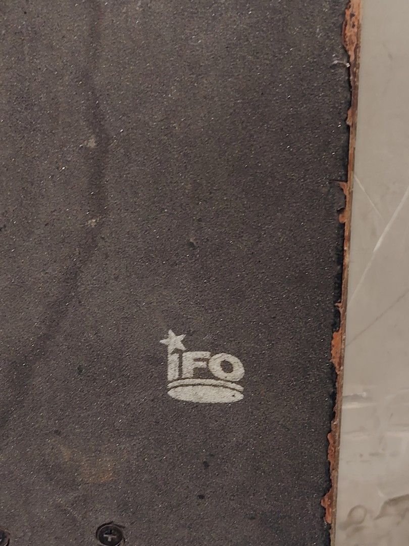 IFO Skateboard (Category: Skates, Rollerblades & Scooters) located in Valenzuela. Submitted by upcycle_things (Listing ID 1438960677, Image 3). Description: - IFO skateboard with a blue and grey design. - Textured grip tape for better control. - Features visible trucks and wheels. - IFO logo displayed on trucks and deck bottom. - Includes a blue stripe design..