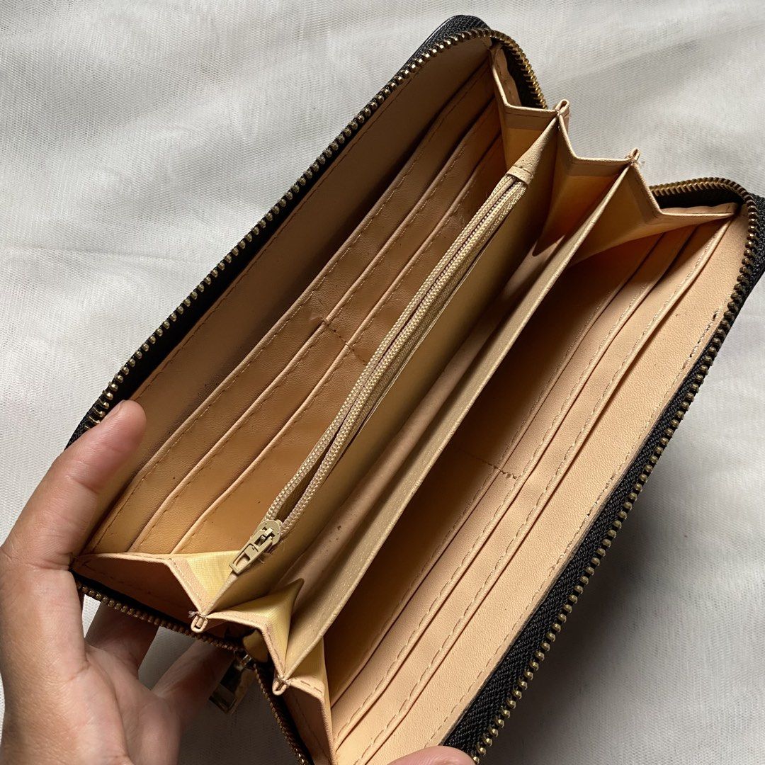 Japan Black Wallet with Wristlet (Category: Wallets & Card holders) located in Makati City. Submitted by imsuli (Listing ID 1438929919, Image 3). Description: ෆ Negotiable ෆ Black zippered wallet ෆ Gold-colored flower emblem ෆ Multiple card slots ෆ Zippered compartment ෆ Smooth material ෆ Wrist strap included.