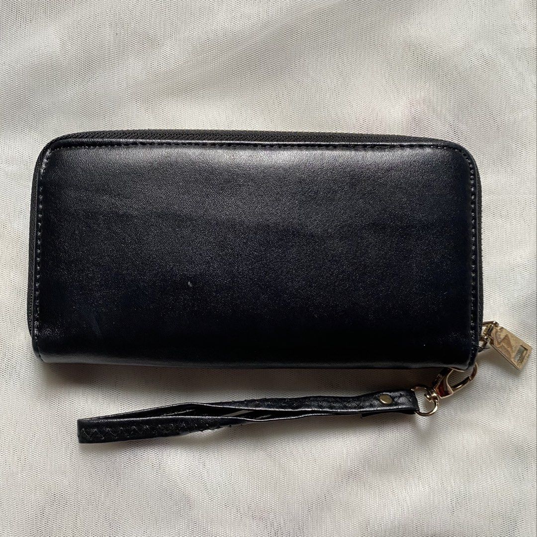 Japan Black Wallet with Wristlet (Category: Wallets & Card holders) located in Makati City. Submitted by imsuli (Listing ID 1438929919, Image 2). Description: ෆ Negotiable ෆ Black zippered wallet ෆ Gold-colored flower emblem ෆ Multiple card slots ෆ Zippered compartment ෆ Smooth material ෆ Wrist strap included.