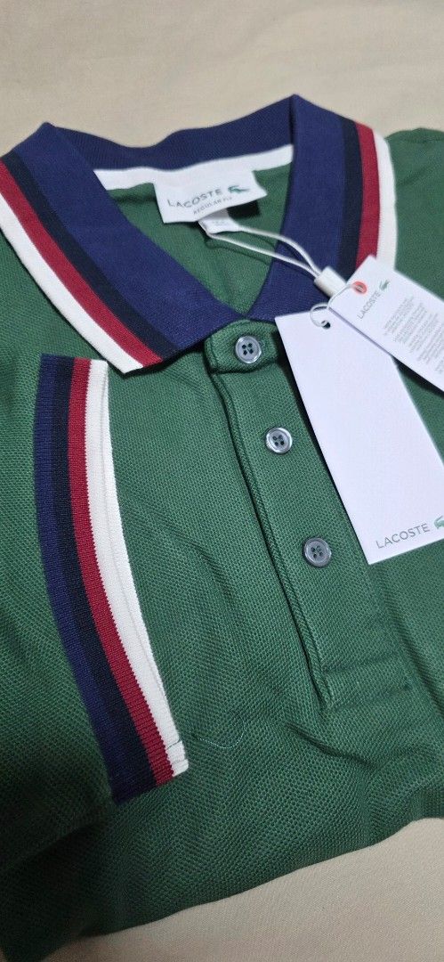 Lacoste Green Polo Shirt (Category: Tshirts & Polo Shirts ) located in Quezon City. Submitted by yGGGG (Listing ID 1439038233, Image 3). Description: - Brandnew Authentic Lacoste polo shirt - Color: Green - Classic collar with navy, red, and white stripes - Small Lacoste logo on chest - Striped sleeve cuffs - Includes original tags - Style: PH3461 - Size: Regular fit 4 Medium - Dimes: 20x27inches .