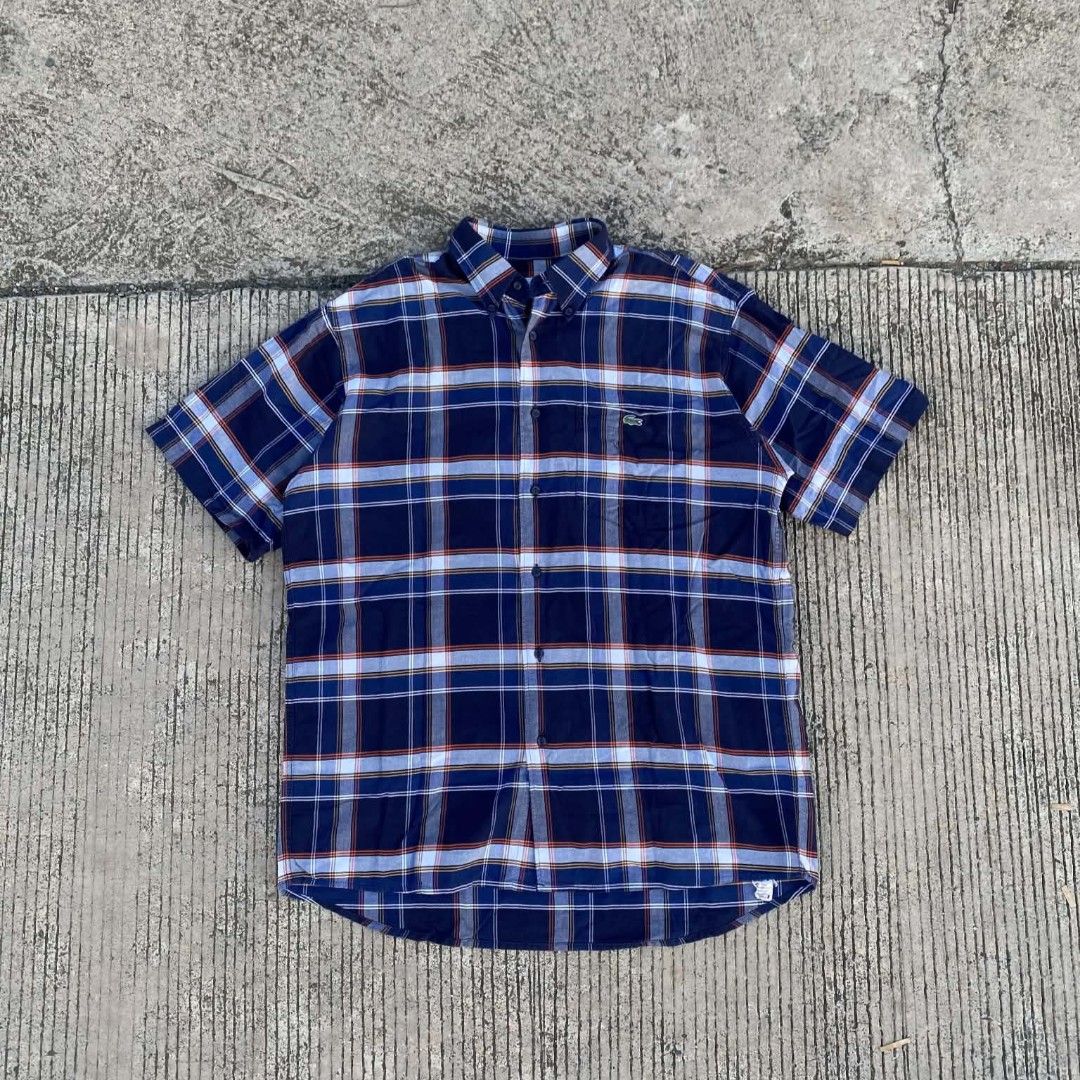 Lacoste Short Sleeve Plaid Shirt (Category: Tshirts & Polo Shirts ) located in Butuan. Submitted by johnraven086338 (Listing ID 1438926749, Image 1). Description: - Lacoste short sleeve shirt - Plaid pattern - Button-down collar - Chest pocket - Classic fit - Blue, white, and red color scheme - Lightweight fabric.